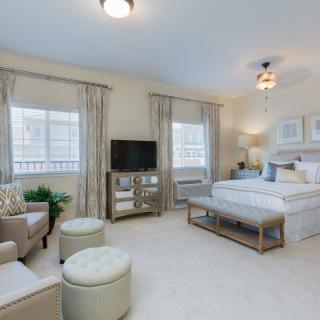A spacious and well-decorated bedroom with modern furnishings.