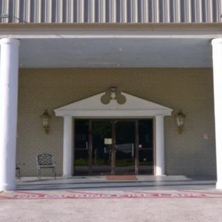 A building entrance featuring large columns and a portico.