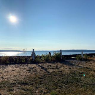 A serene view of the ocean under a bright sun, showcasing the beauty of nature.