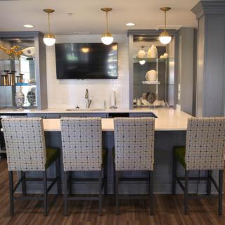 Modern kitchen with island seating and pendant lighting.