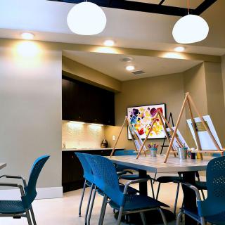 A modern art studio with easels and bright lighting.