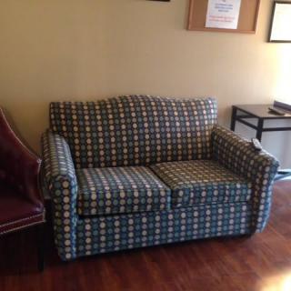 A plaid-patterned sofa in a living room setting.
