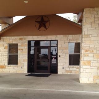 Entrance of a building with stone facade and star decoration.