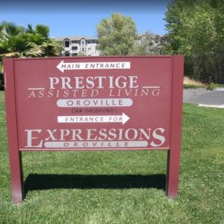 Sign for Prestige Assisted Living and Expressions with directional arrows.