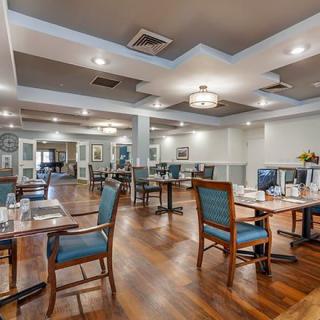 A modern and elegant restaurant dining area with wooden floors and stylish lighting.
