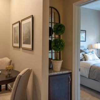 A cozy interior view showcasing a transition from the living room to the bedroom.