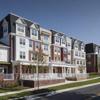 A modern residential apartment complex in a suburban neighborhood.