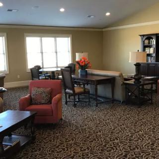 A cozy living room with comfortable furniture and ample natural light.