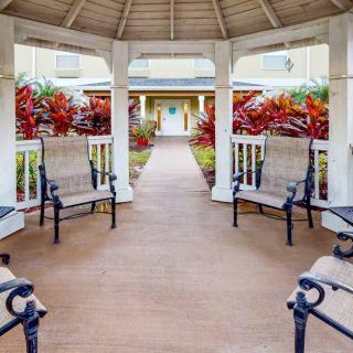 A welcoming gazebo with benches, surrounded by vibrant landscaping.