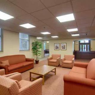 A comfortable office lobby with sofas and chairs arranged around a coffee table.