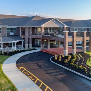 A modern residential building with a welcoming entrance and landscaped surroundings.