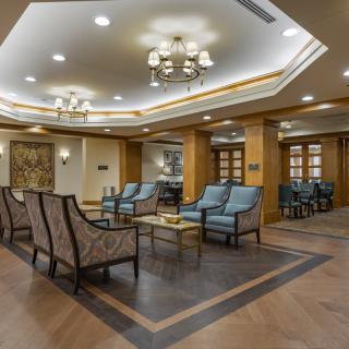 A modern lobby area with elegant seating and chandeliers.