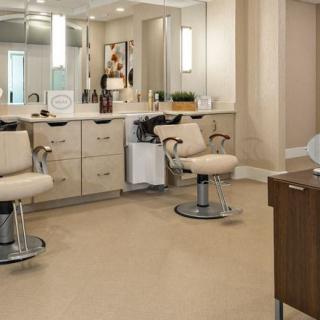 A well-equipped hair salon interior with styling chairs and mirrors.
