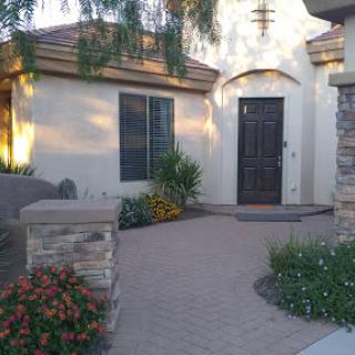 A welcoming entrance to a beautifully landscaped home.