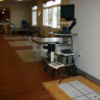 A rehabilitation room equipped with medical and exercise equipment for physical therapy.