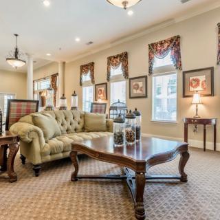 A well-decorated living room with traditional furniture and elegant lighting.
