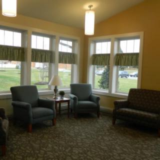 A cozy living room with comfortable seating and large windows.