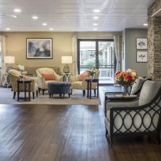 A cozy and elegantly decorated lobby with comfortable seating arrangements and warm lighting.
