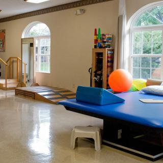 A spacious rehabilitation center equipped with various exercise and therapy tools.