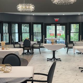 A beautifully arranged dining area featuring modern decor and elegant chandeliers.