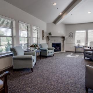 A cozy living room with comfortable seating, a fireplace, and ample natural light.