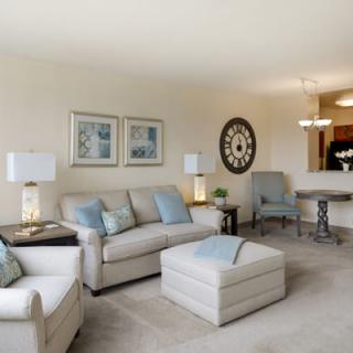 A modern living room with neutral tones and cozy furnishings.