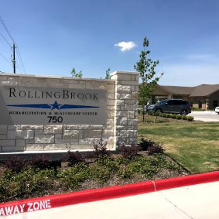 Entrance sign of Rolling Ridge, showcasing a welcoming exterior in a sunny environment.