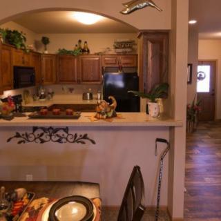 A cozy kitchen and dining area featuring wooden cabinets and decorative accents.
