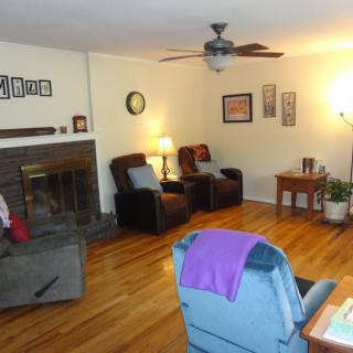 A cozy living room with comfortable seating and a fireplace.