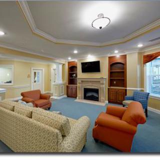 A cozy living room featuring comfortable seating and a warm fireplace.