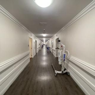 A long hospital hallway with medical equipment along the walls.