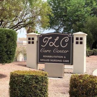 Sign for TLC Care Center indicating rehabilitation and skilled nursing services, surrounded by landscaped greenery.