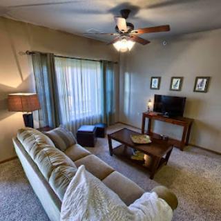 A cozy and inviting living room featuring comfortable seating and warm lighting.