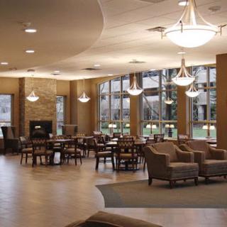 A spacious and modern lounge area featuring comfortable seating and ample natural light.
