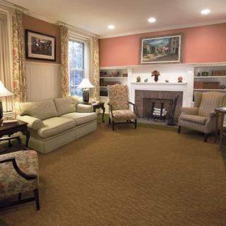 A cozy traditional living room with comfortable seating and a fireplace.