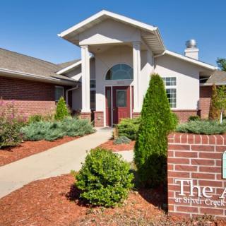A modern building entrance with well-maintained landscaping.