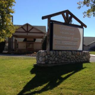 Outdoor sign in front of a church building on a sunny day.