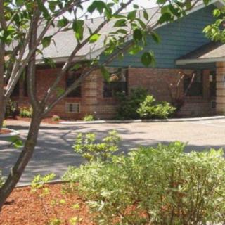 A residential house with landscaped garden and driveway.
