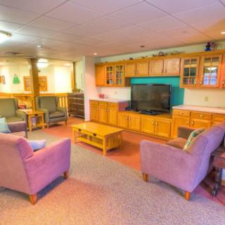 A cozy living room with comfortable seating and a large television.