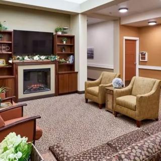 A cozy living room with a fireplace, television, and comfortable seating.