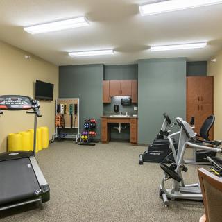 A well-equipped fitness center with treadmills, stationary bikes, and weights.