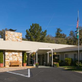 The exterior view of a building with trees in the background and a clear blue sky.