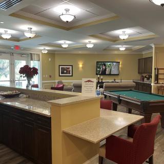 A modern lounge featuring a pool table and comfortable seating areas.