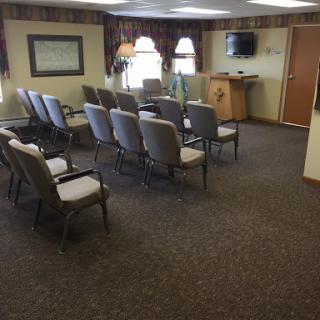 A spacious waiting room featuring rows of chairs and a welcoming ambiance.