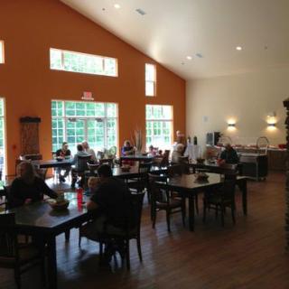 A cozy dining area with people enjoying their meals in a well-lit space.