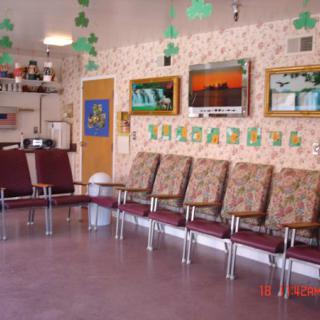 A waiting room with chairs, televisions, and decorative elements.
