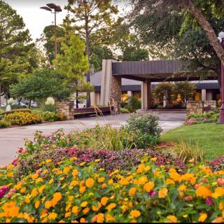 A peaceful garden with colorful flowers in front of a building.