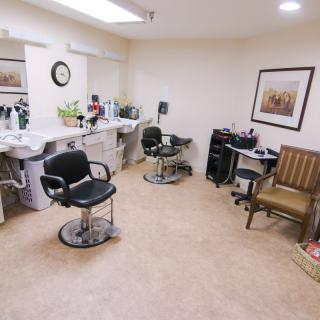 A cozy hair salon setup with two barber chairs and mirrors.