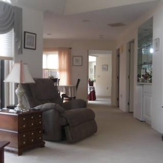 A cozy living room with an armchair and homey decor.