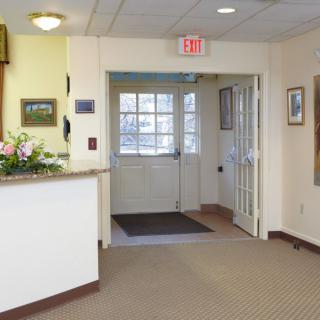 A welcoming lobby area with a reception desk and entrance door.